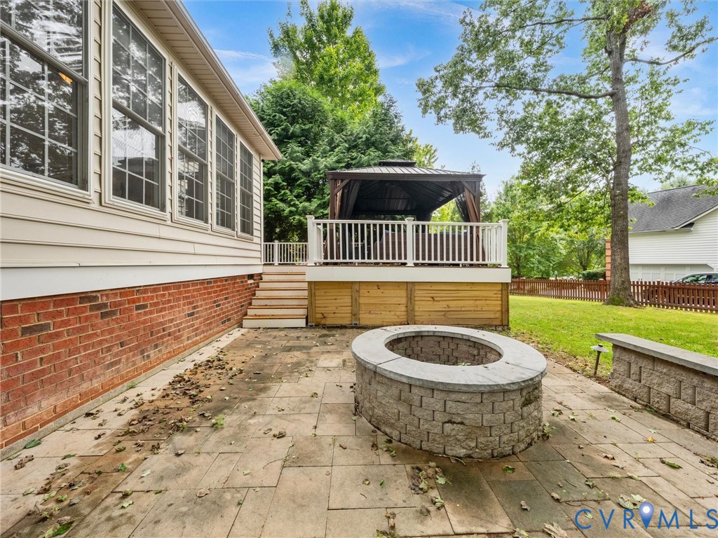 Expansive stone patio with a built-in fire pit