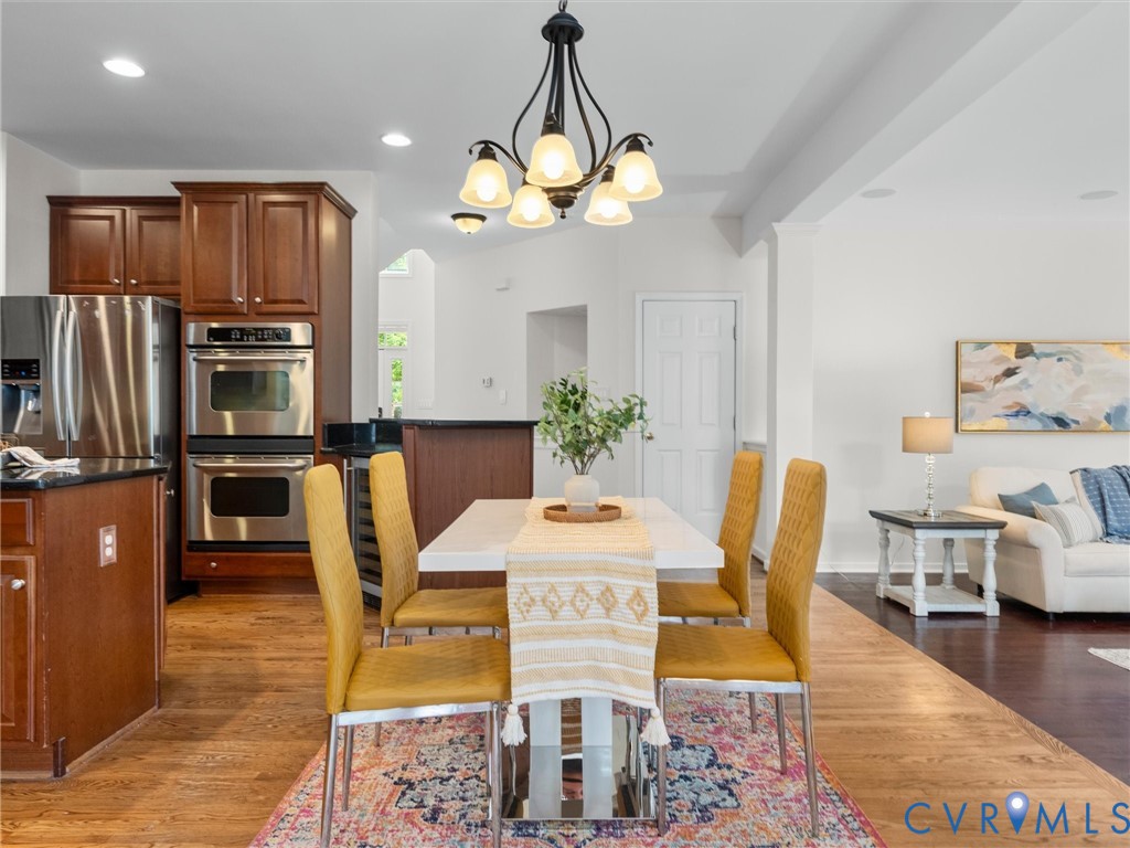 Kitchen with stainless steel appliances, dark wood cabinetry, and a built-in double oven