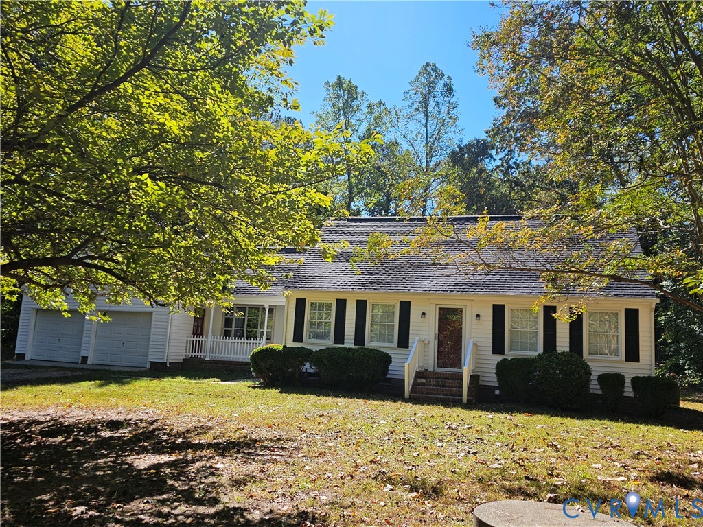 Single-story exterior featuring white horizontal siding, dark window shutters, a front porch with railing, and an attached two-car garage Single-story exterior featuring white horizontal siding, dark window shutters, a front porch with railing, and an attached two-car garage