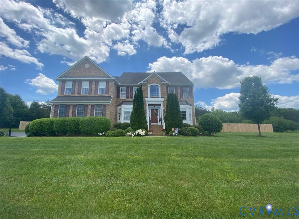 Brick facade colonial-style residence with a prominent bay window Brick facade colonial-style residence with a prominent bay window