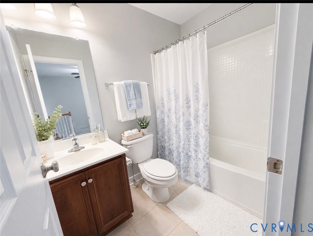 Full bathroom featuring a single vanity with wood-finish cabinetry, a white countertop, and a built-in sink
