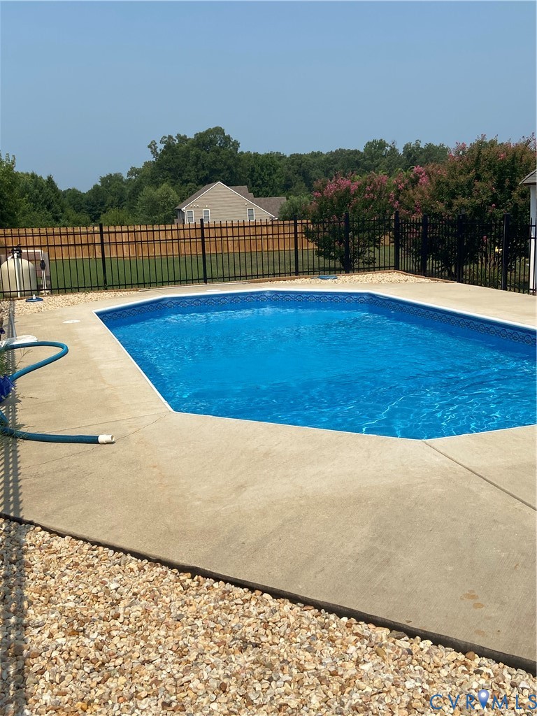 Geometric in-ground pool with concrete surround and gravel border