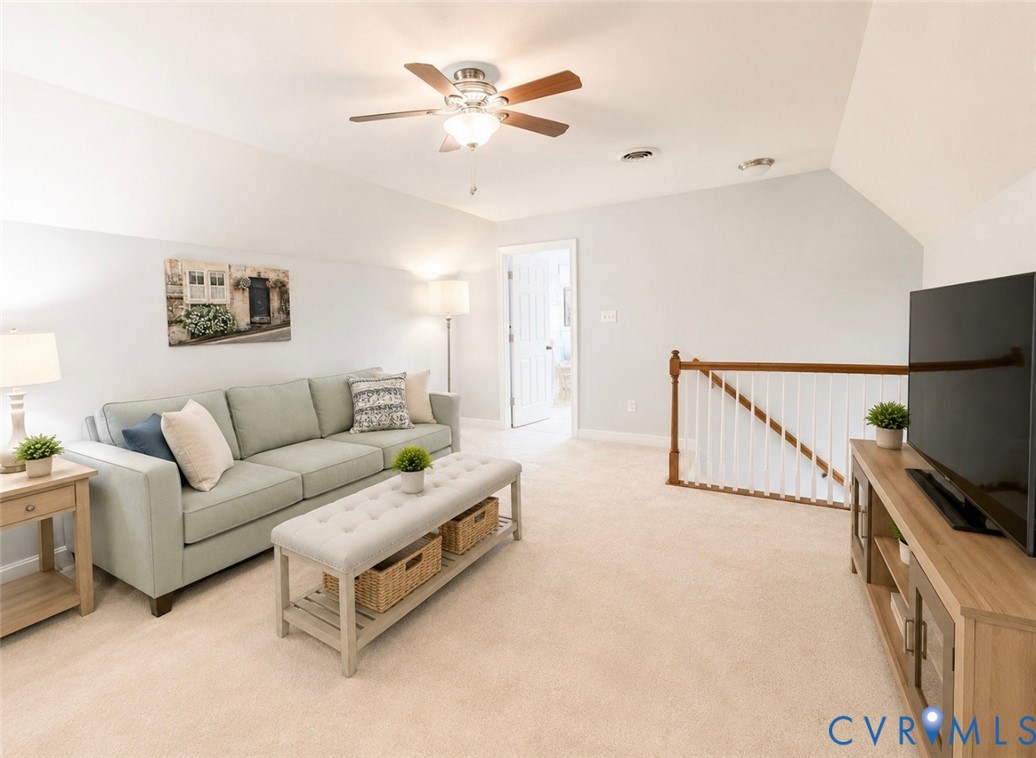 Carpeted bonus room featuring a ceiling fan with light, recessed lighting, and a white balustrade with wood-finish top rail