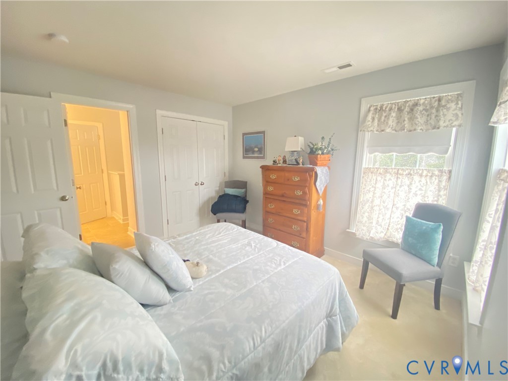 Bedroom featuring light neutral wall paint and carpeting