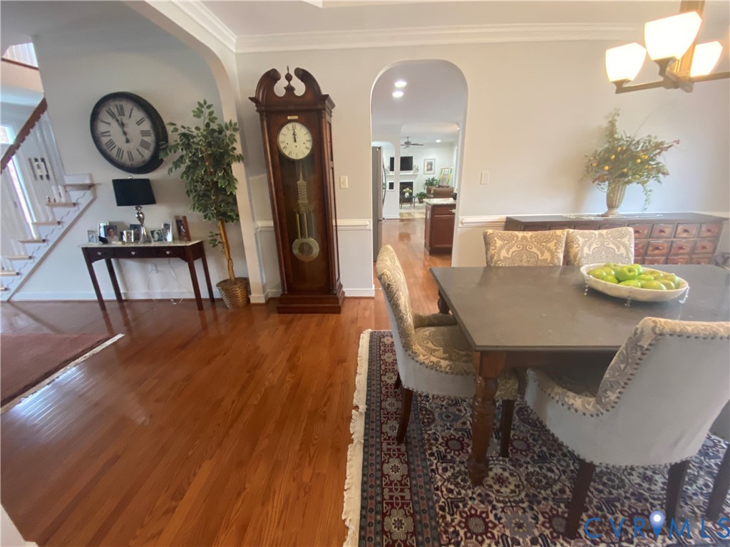 Hardwood flooring throughout the main level with crown molding details