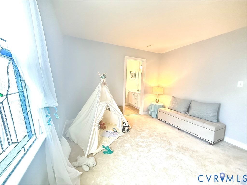 Carpeted interior room with light-toned walls