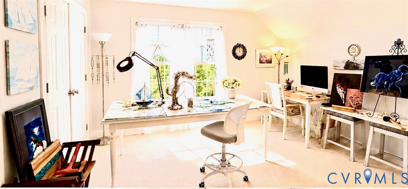 Bright room with a large window, light-toned walls, and carpet flooring
