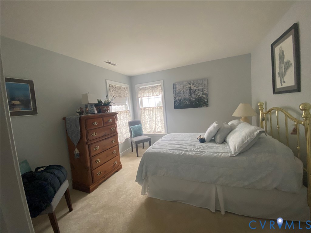 Bedroom featuring neutral carpeting and light-colored walls