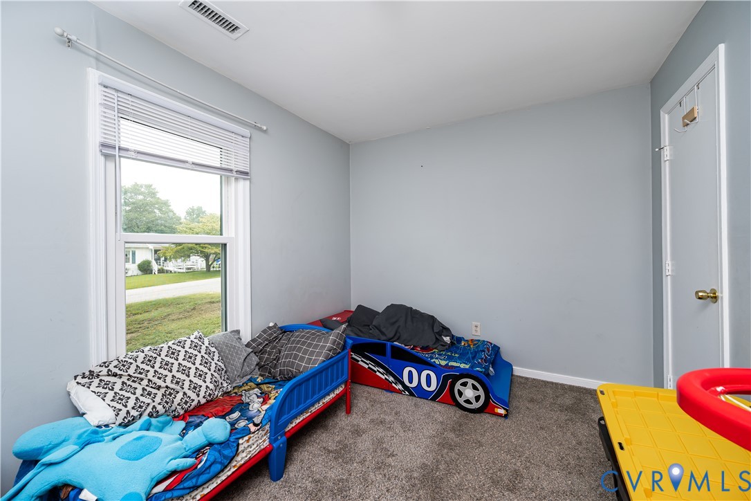Room featuring light gray walls and gray carpeting