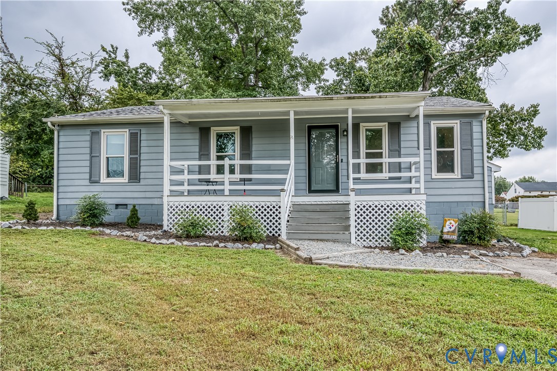 Light blue horizontal siding exterior with gray shutters and a covered porch