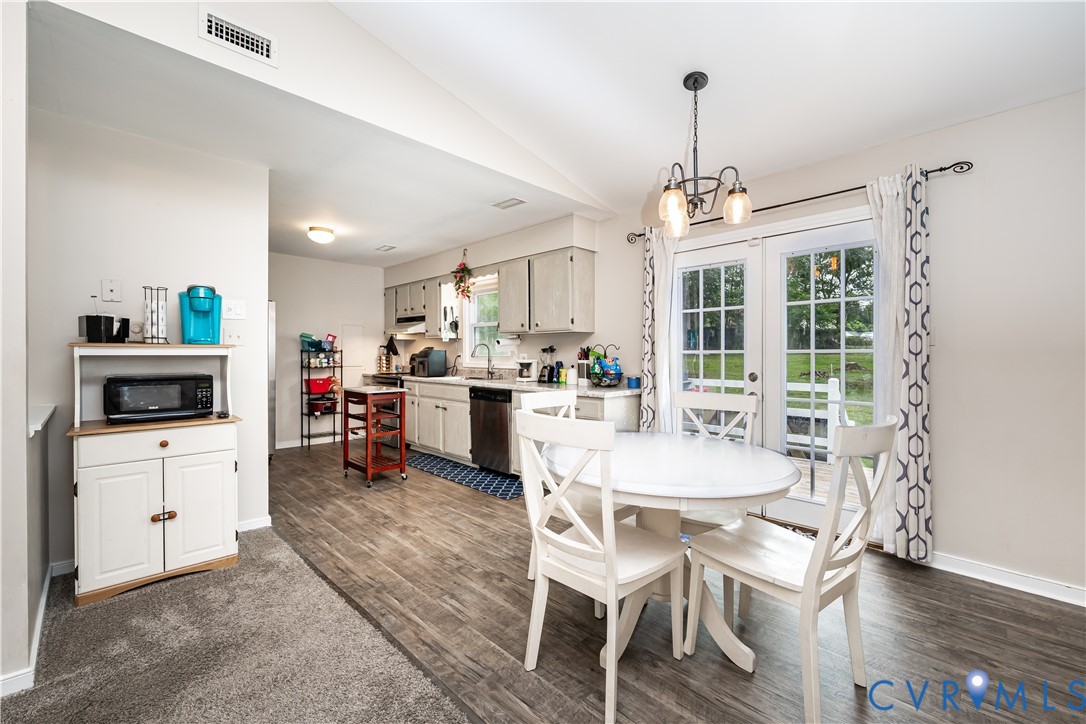 Open-concept kitchen and dining area featuring wood-finish flooring