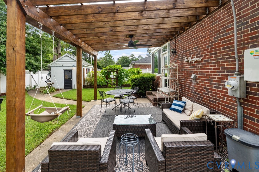 Covered patio featuring a wood pergola and ceiling fan