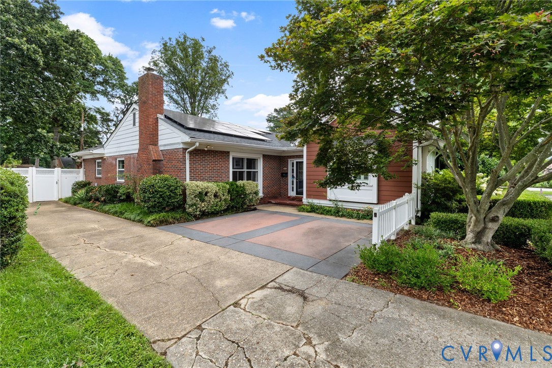 Brick and siding exterior with a prominent brick chimney