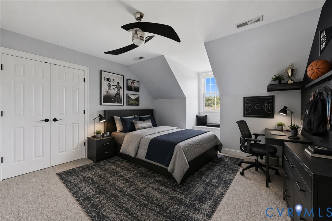Bedroom featuring sloped ceilings, light gray wall color, light tan carpeting, and a built-in window seat