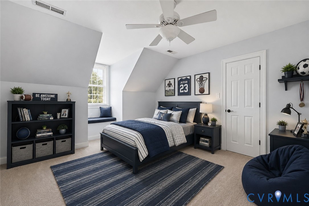 Attic bedroom with neutral carpeting and light gray walls