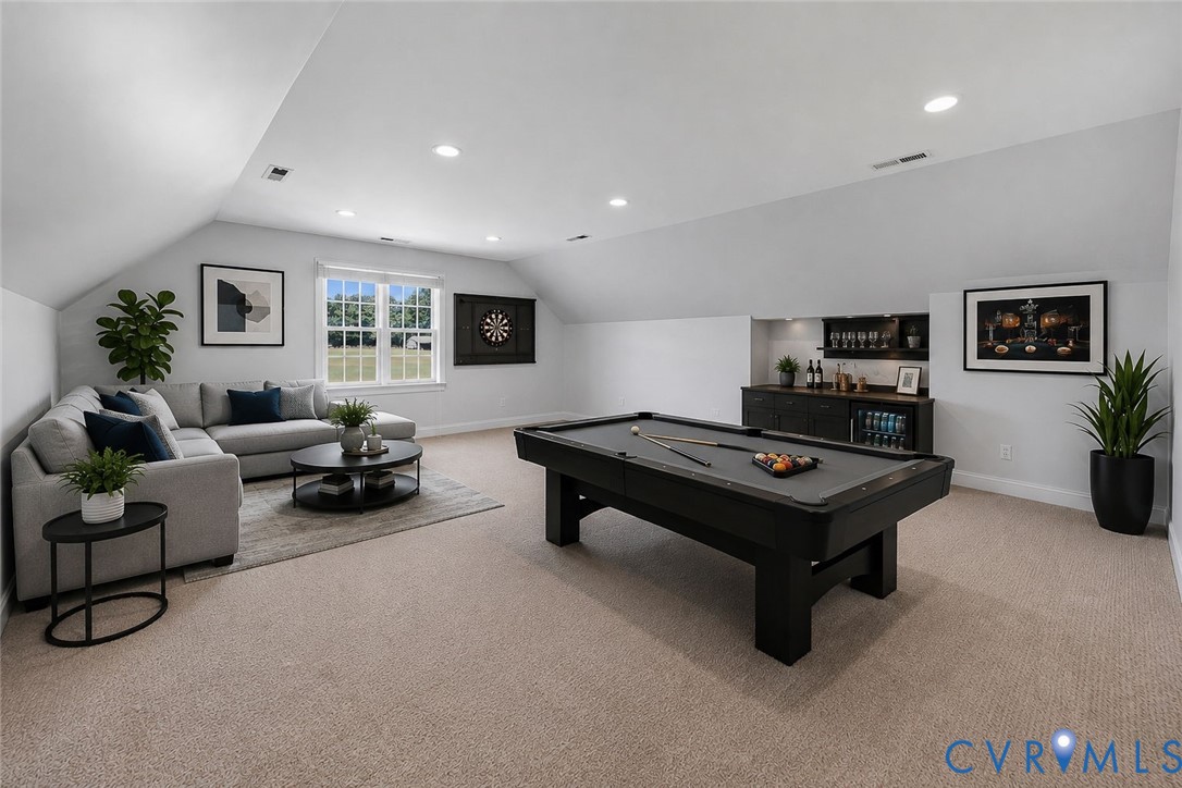 Spacious bonus room featuring plush carpeting, recessed lighting, a built-in wet bar with shelving, and large windows providing ample natural light