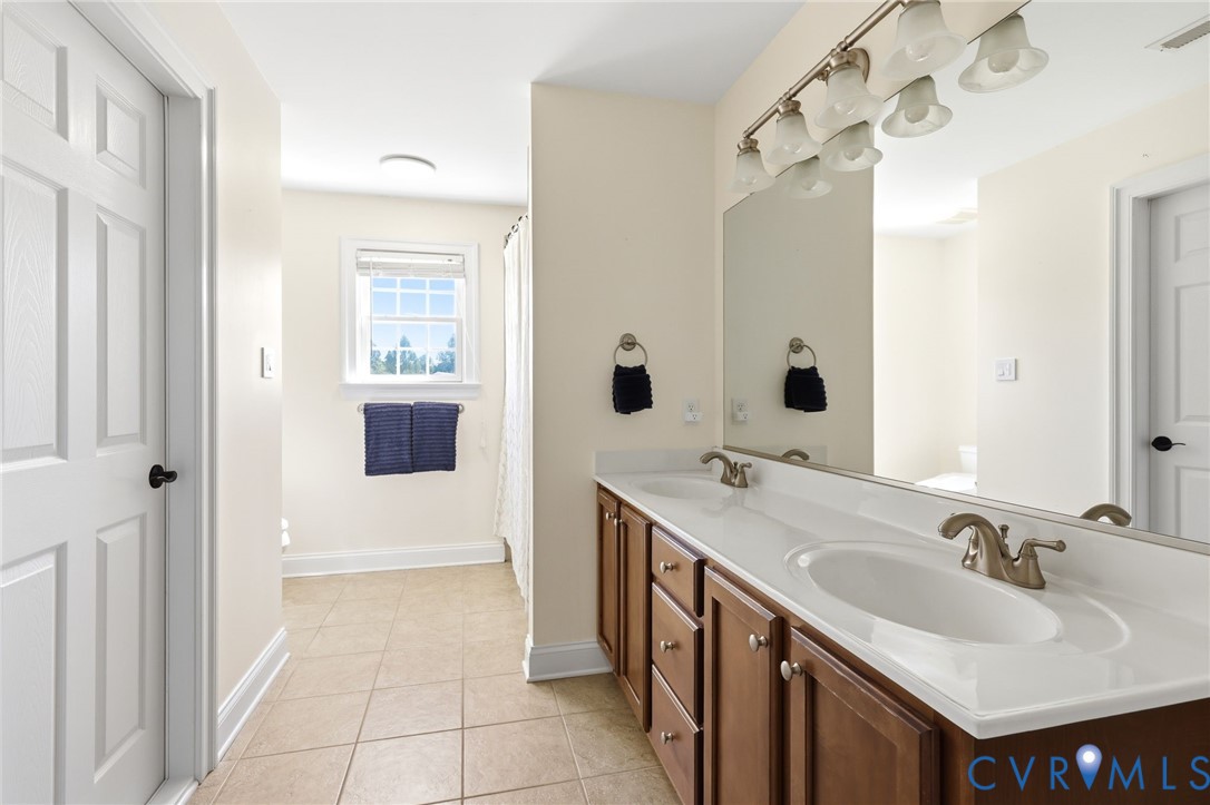 Dual vanity with undermount sinks and brushed nickel faucets