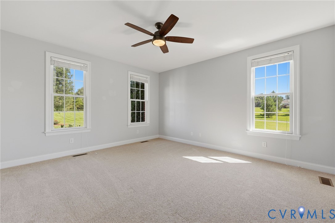 Carpeted room with light grey walls and white trim
