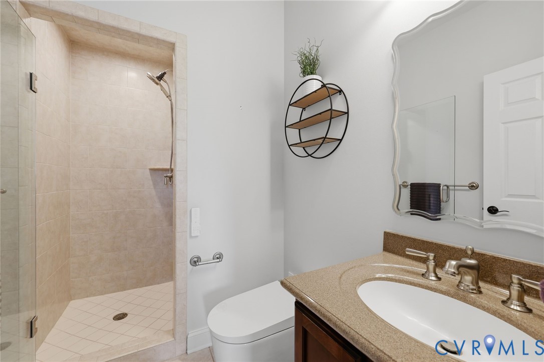 Guest Bathroom first floor Walk-in shower with light-toned tile surround and glass enclosure