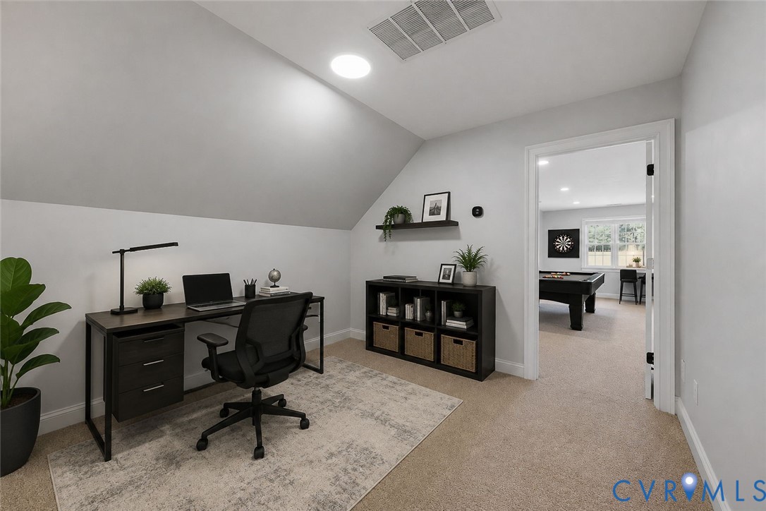 Attic room with sloped ceilings and recessed lighting