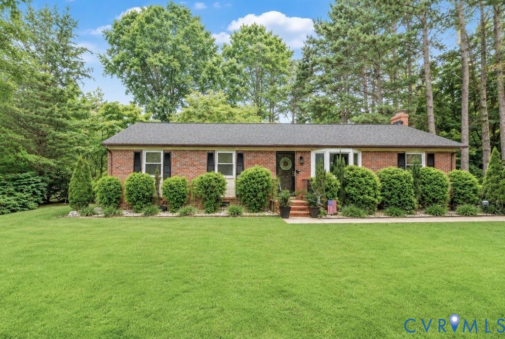 Wonderful curb appeal with mature landscaping and manicured lawn.