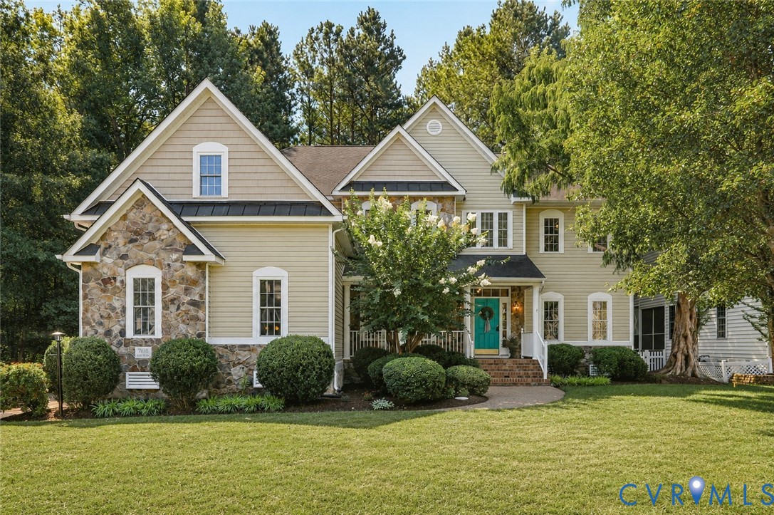 Elegant two-story residence featuring a stone and siding exterior with multiple gabled rooflines and architectural detail Elegant two-story residence featuring a stone and siding exterior with multiple gabled rooflines and architectural detail