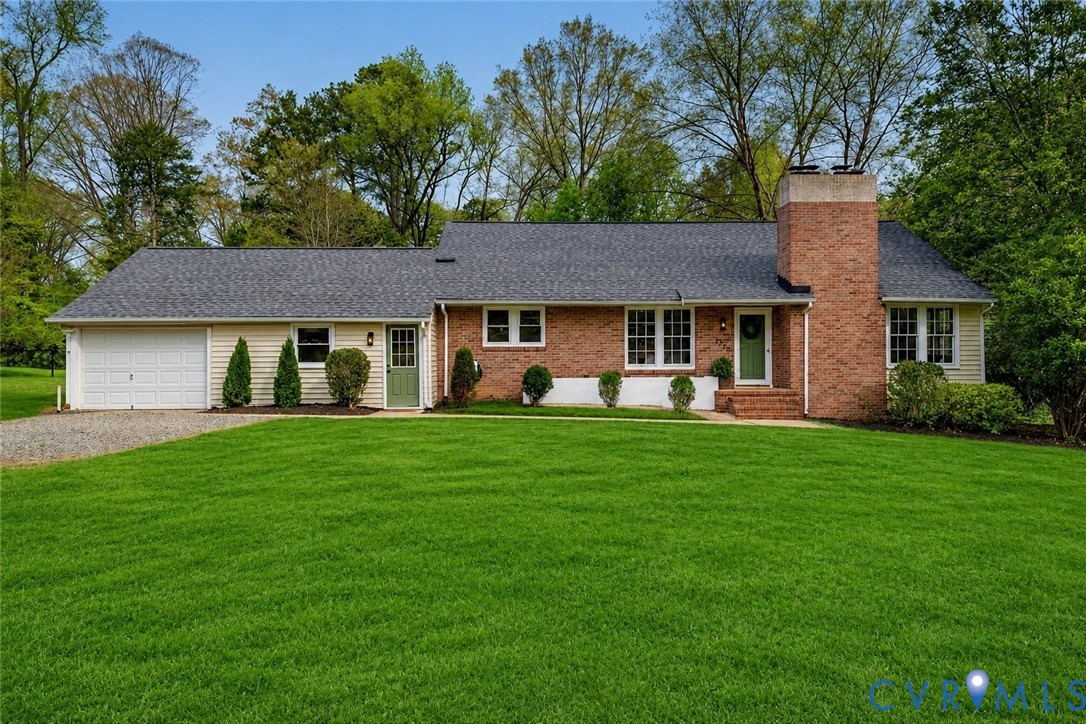 Ranch-style residence featuring a brick and siding exterior, a prominent brick chimney, and a dark shingle roof Ranch-style residence featuring a brick and siding exterior, a prominent brick chimney, and a dark shingle roof