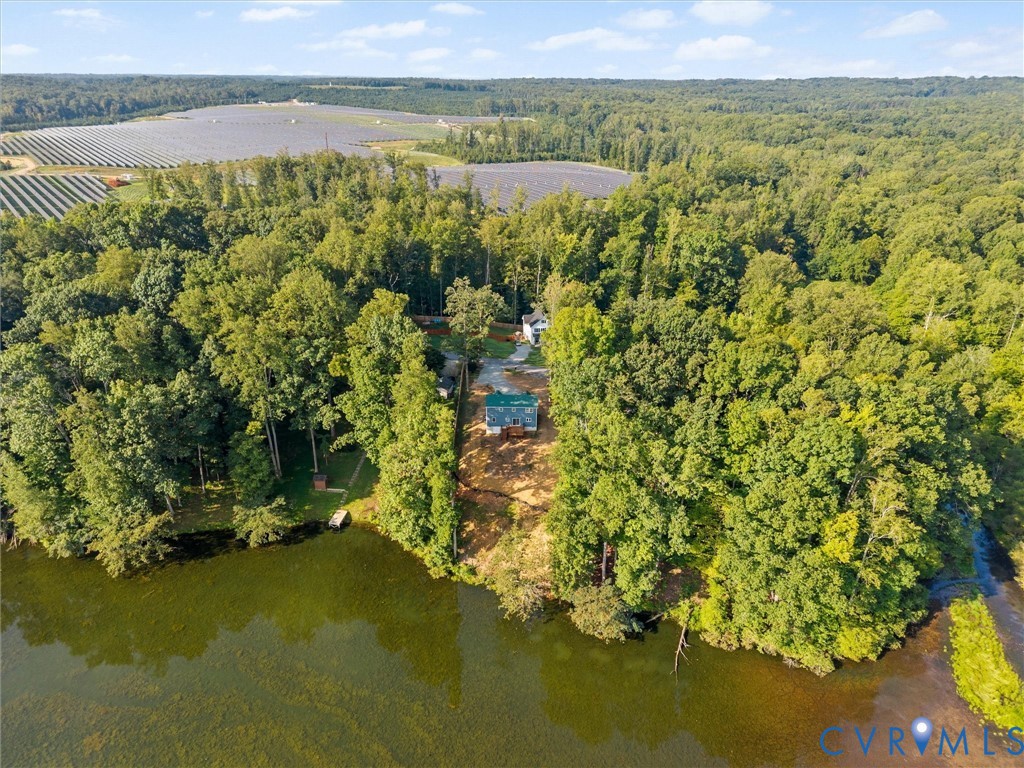 Waterfront property featuring extensive tree coverage and a private dock