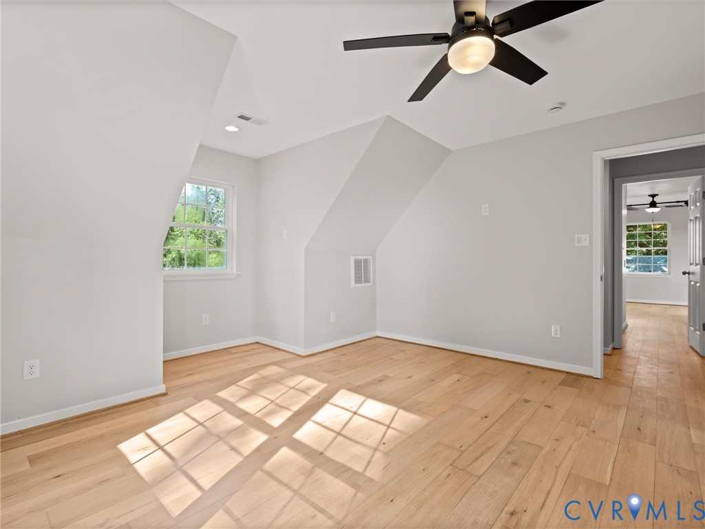Hardwood flooring, sloped ceiling, recessed lighting, and a modern ceiling fan