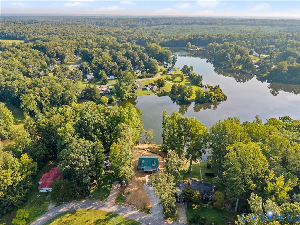 Expansive wooded landscape with a prominent lake and surrounding properties
