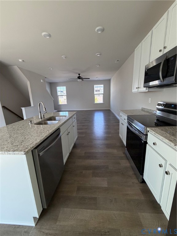 Open-concept kitchen and living area featuring wood-finish flooring