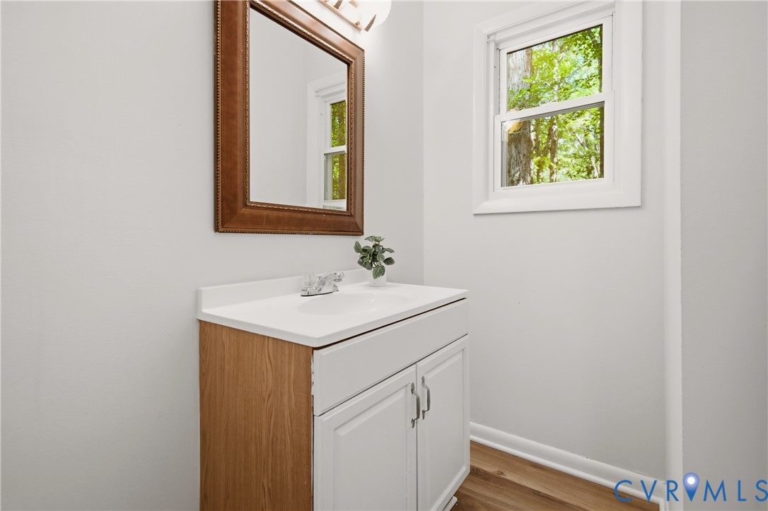 Light-toned vanity with a white countertop and an integrated sink