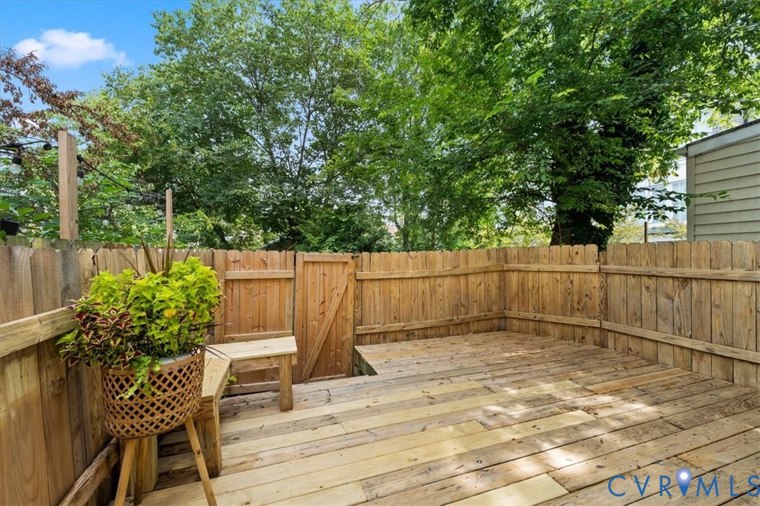 Wood deck with perimeter privacy fencing and a gated entry