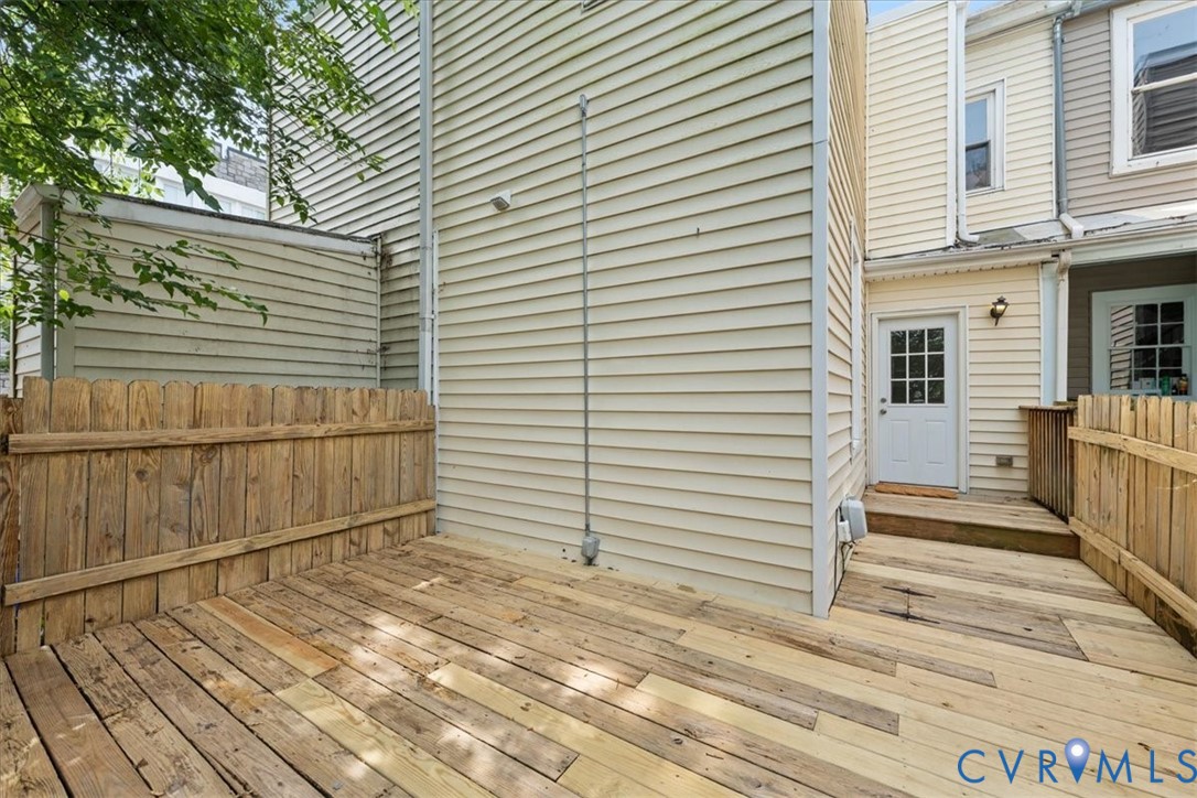 Wood-finish decking with wood fencing and exterior siding