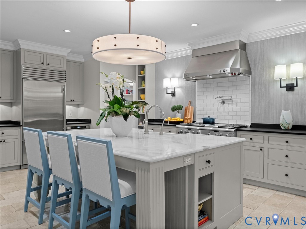 Kitchen with large marble island and bar seating
