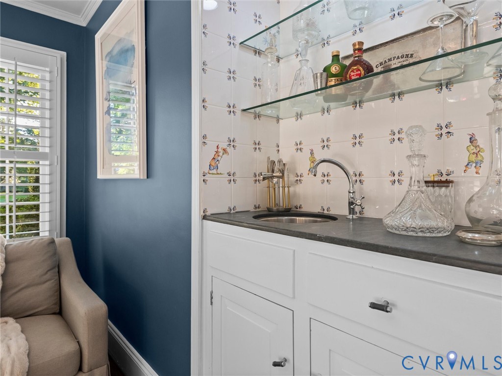 Wet bar in handsome den/office with soapstone counters