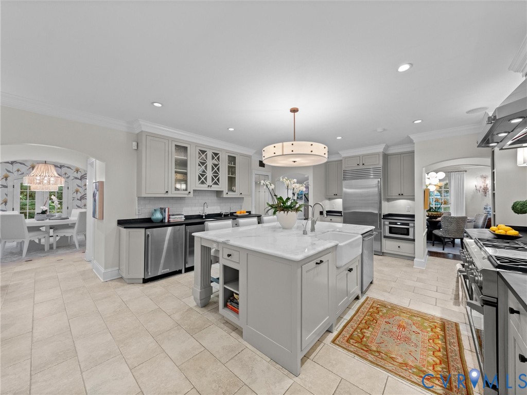 Kitchen with heated tile floors opening to breakfast, dining and family rooms