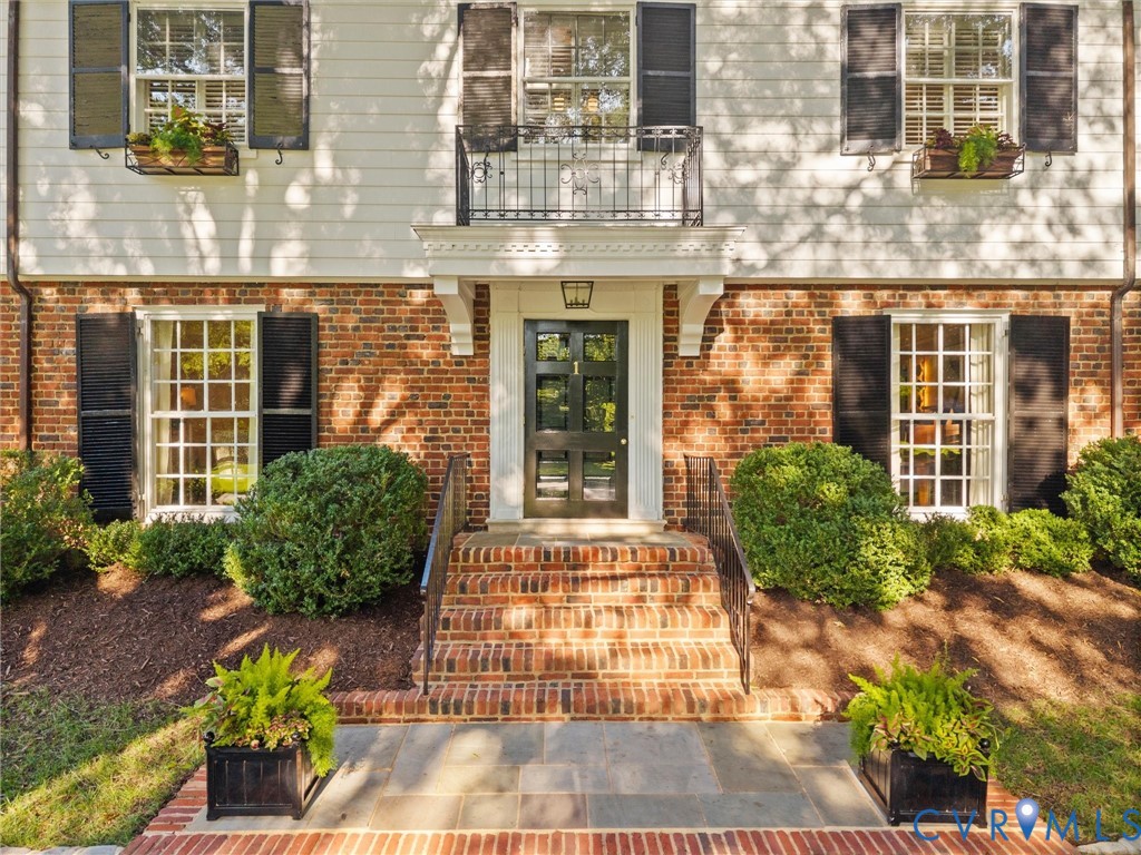 Timeless architectural brick and frame detailing with flower boxes Timeless architectural brick and frame detailing with flower boxes