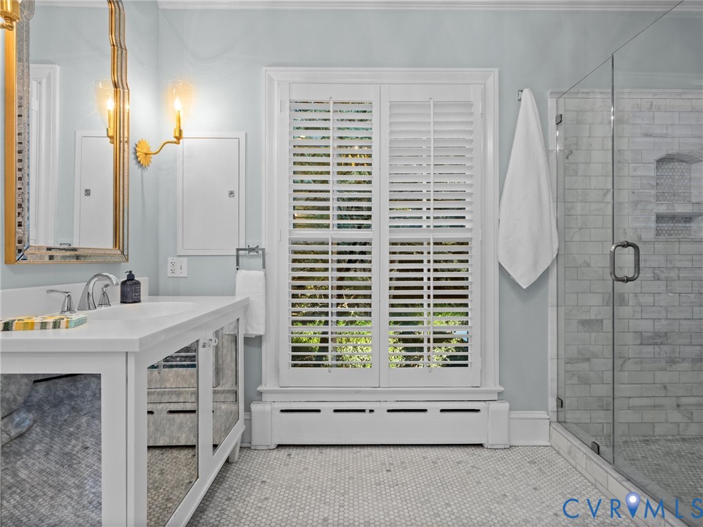 Walk-in shower with Carrara marble tiled floors