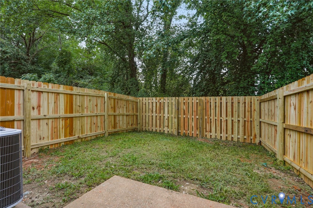 Private backyard featuring a new wood privacy fence