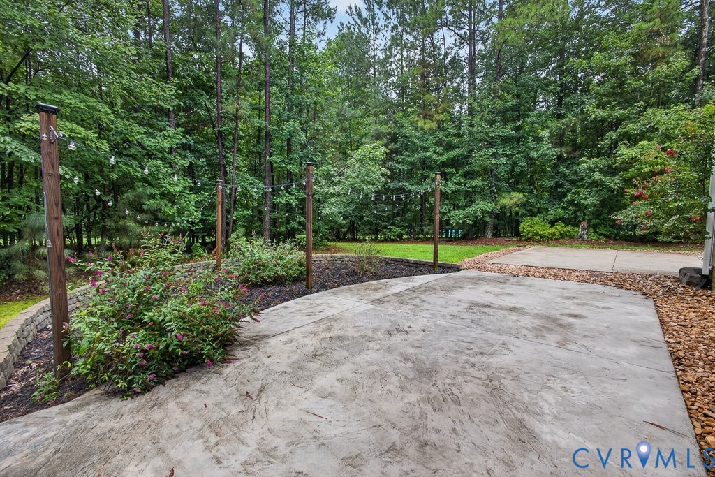 Expansive concrete patio with integrated string lighting