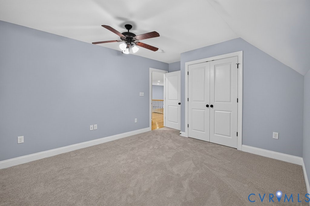 Recessed ceiling with an integrated ceiling fan, light gray wall finish, white trim, and light gray carpeting