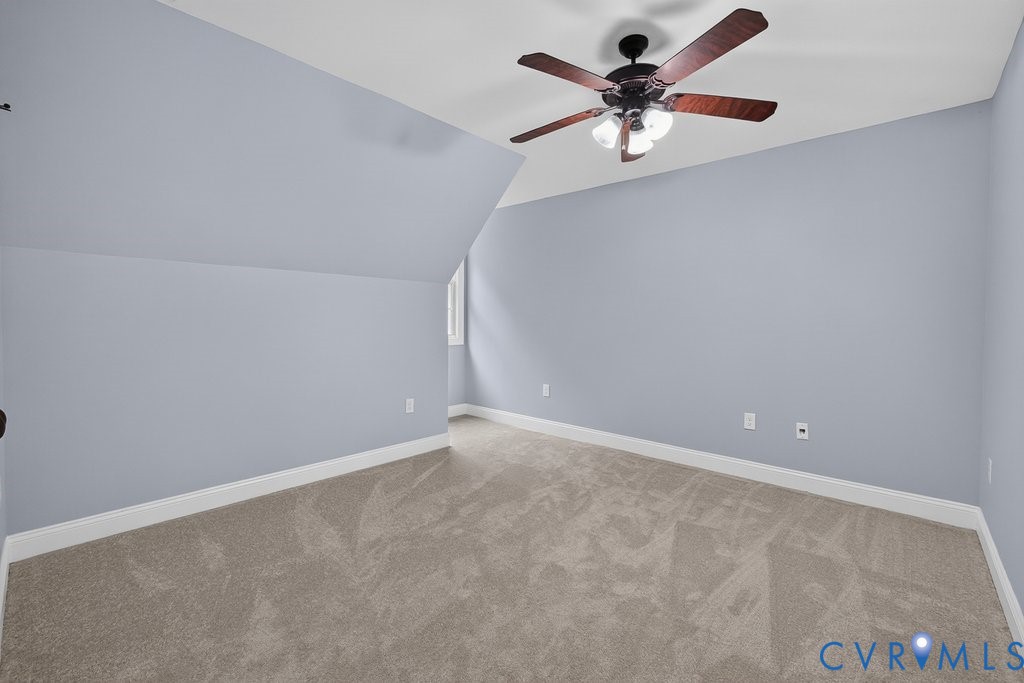 Sloped ceiling, recessed window, ceiling fan with integrated lighting, wall-to-wall carpeting, and light blue wall finish