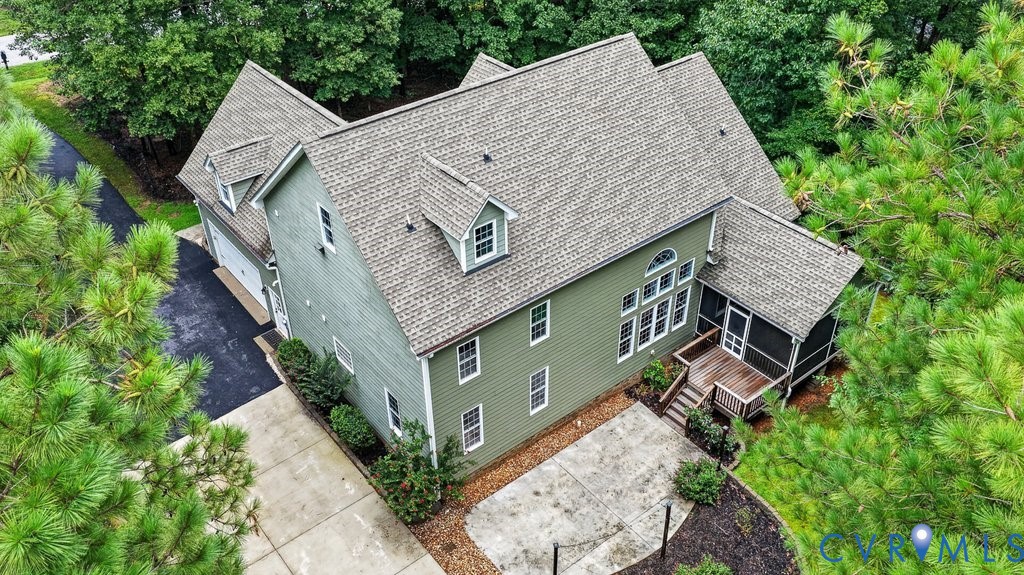 Green siding exterior with a multi-gabled roof and dormer windows