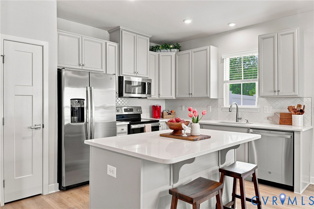 Quartz countertop, tiled backsplash, stainless steel appliances Quartz countertop, tiled backsplash, stainless steel appliances