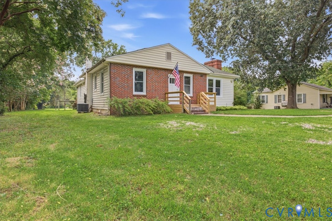 Brick and siding exterior with a wood-framed porch and steps