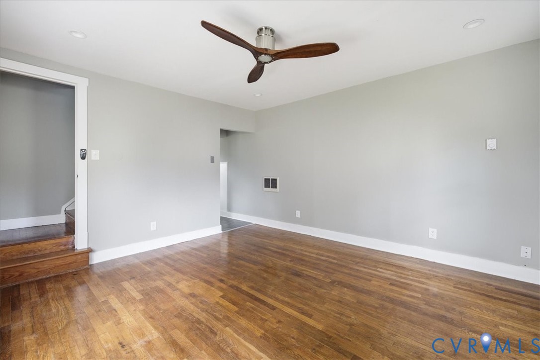 Hardwood flooring, recessed lighting, and a contemporary ceiling fan