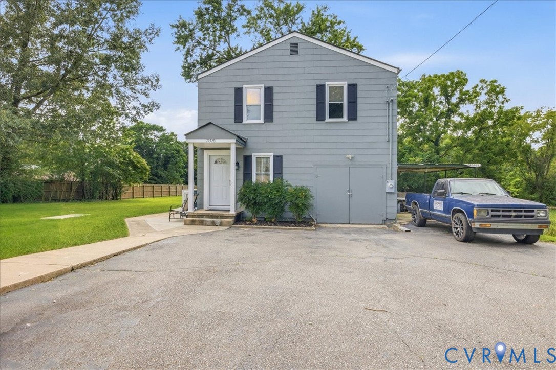 Two-story property with gray siding and black window shutters