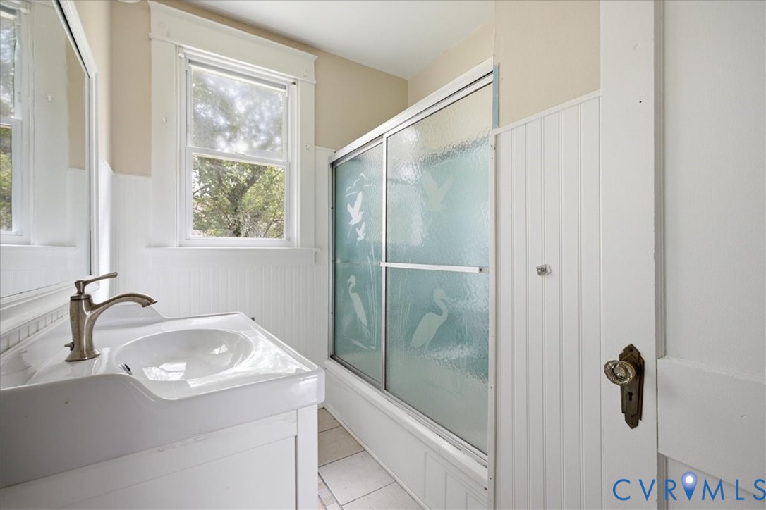 White single vanity with an integrated sink and brushed nickel faucet