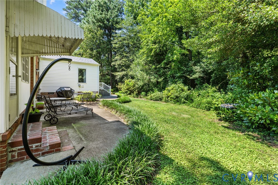 Expansive green lawn with mature trees, offering a secluded outdoor experience